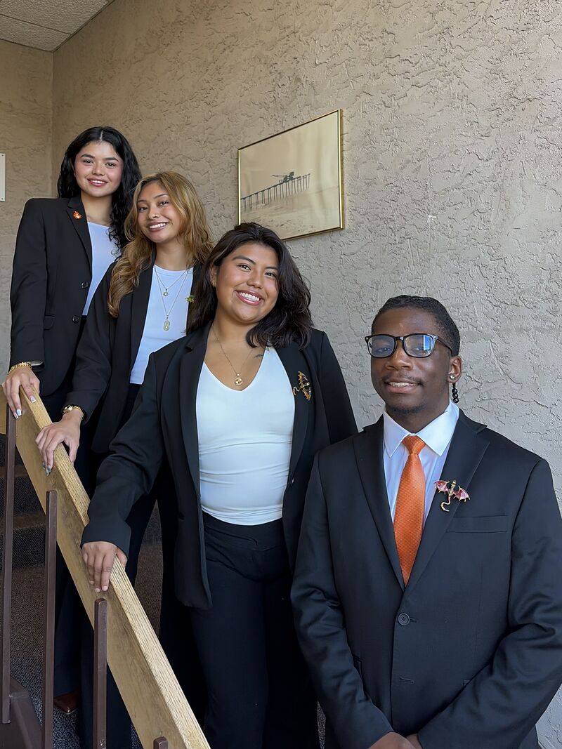 Four Valorix Agency representatives in business dress on the stairs outside the Parsippany office